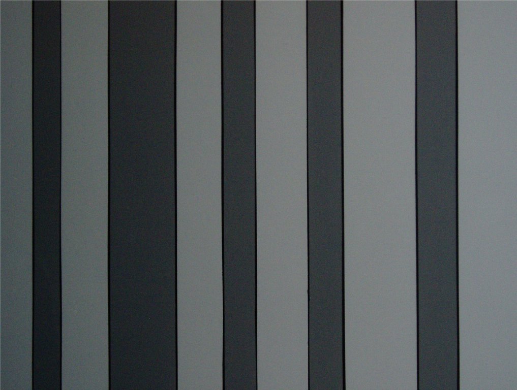 I am a black, dark gray and light gray stripe faux finish. I used to be dark paneling but now I've been upgraded to a modern look!